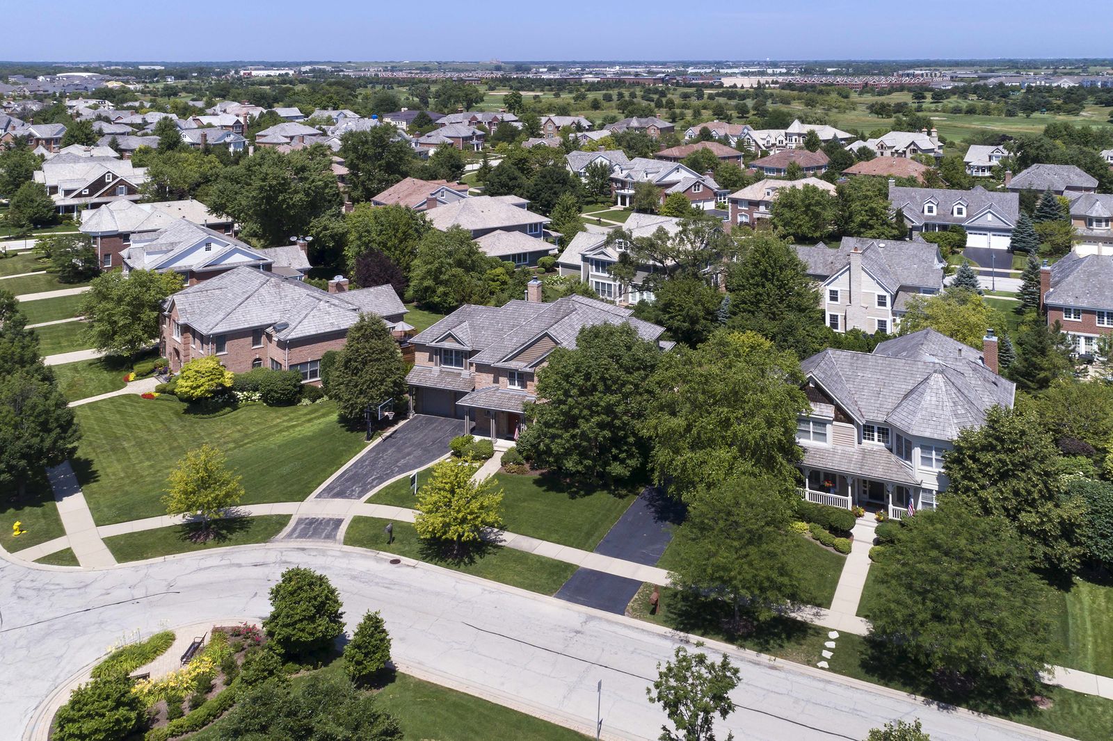 Aerial view of single-family homes with new shingle roofs